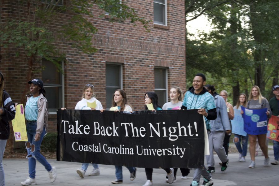 The+LiveWell+staff+at+Coastal+Carolina+University+holding+up+a+banner+during+the+Take+Back+the+Night+march+on+Oct.+4.