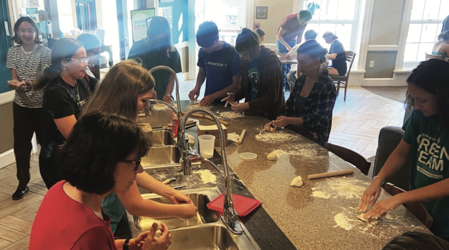 Students learning how to make Italian pasta from Assistant Professor of Italian Arianna Fognani.