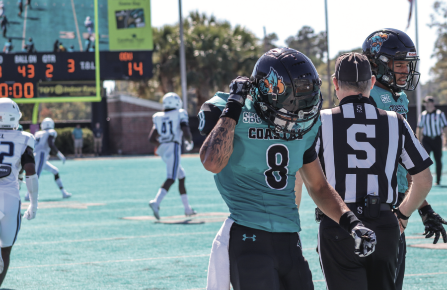 Junior wide receiver Tyson Mobley takes off his helmet and walks to the locker room as the Chants are down by seven at halftime.