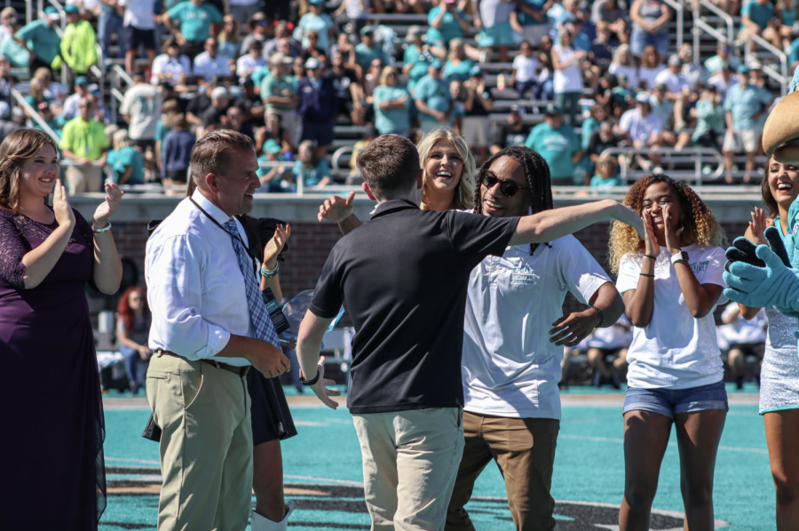Anthony Trey Cornish wins the Spirit of the Chanticleer award with support from the other finalists, CCU President Michael Benson, and Chauncey