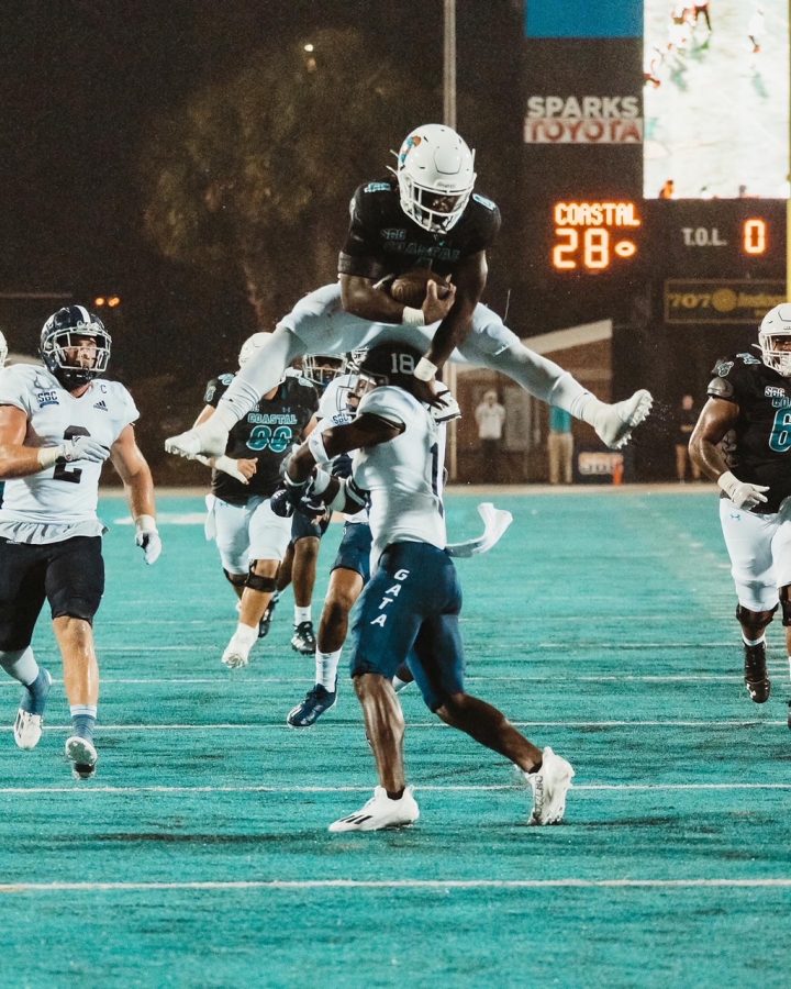 Running back CJ Beasley hurdles over Georgia Southern to score the winning touchdown, ending the game 34-30. Coastal remains undefeated with a record of 5-0. 