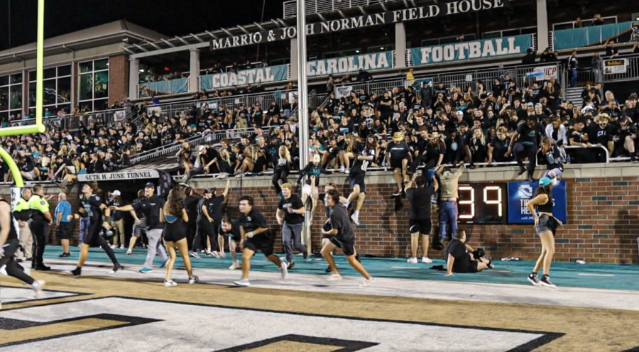 Following+to+football+team%E2%80%99s+win+agaist+Appalachian+State+University+students+jumping+the+wall+onto+the+field.