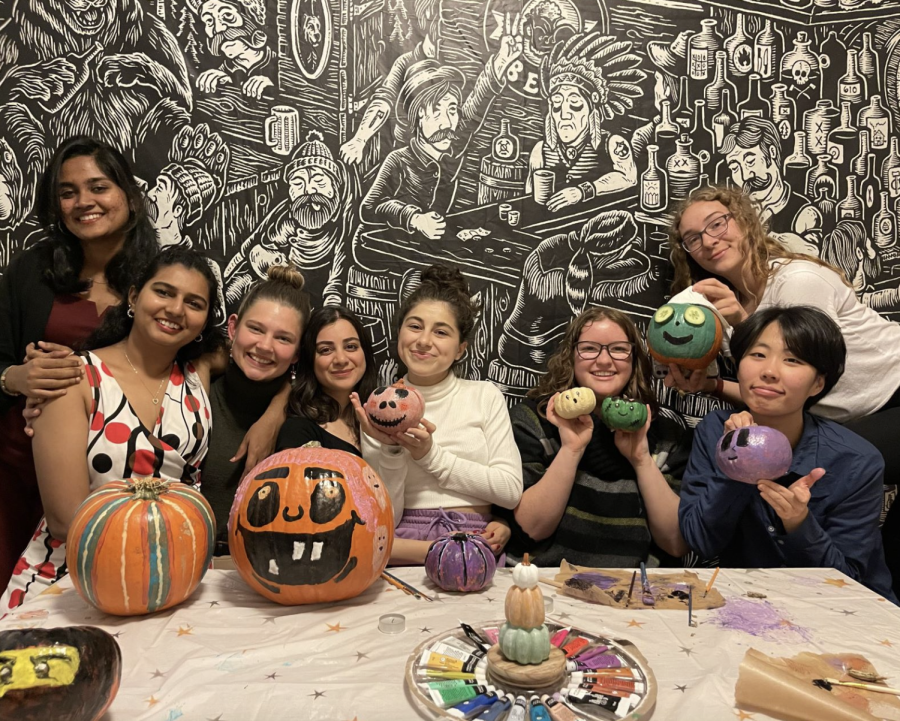 Group of friends paintings pumpkins in preparation for Halloween. (Pictured from left to right: Mathu, India; Haritha, India; Shelbi, United States; Teona, Georgia; Gabby, Canada; Jin, Korea; Steph, Canada.)