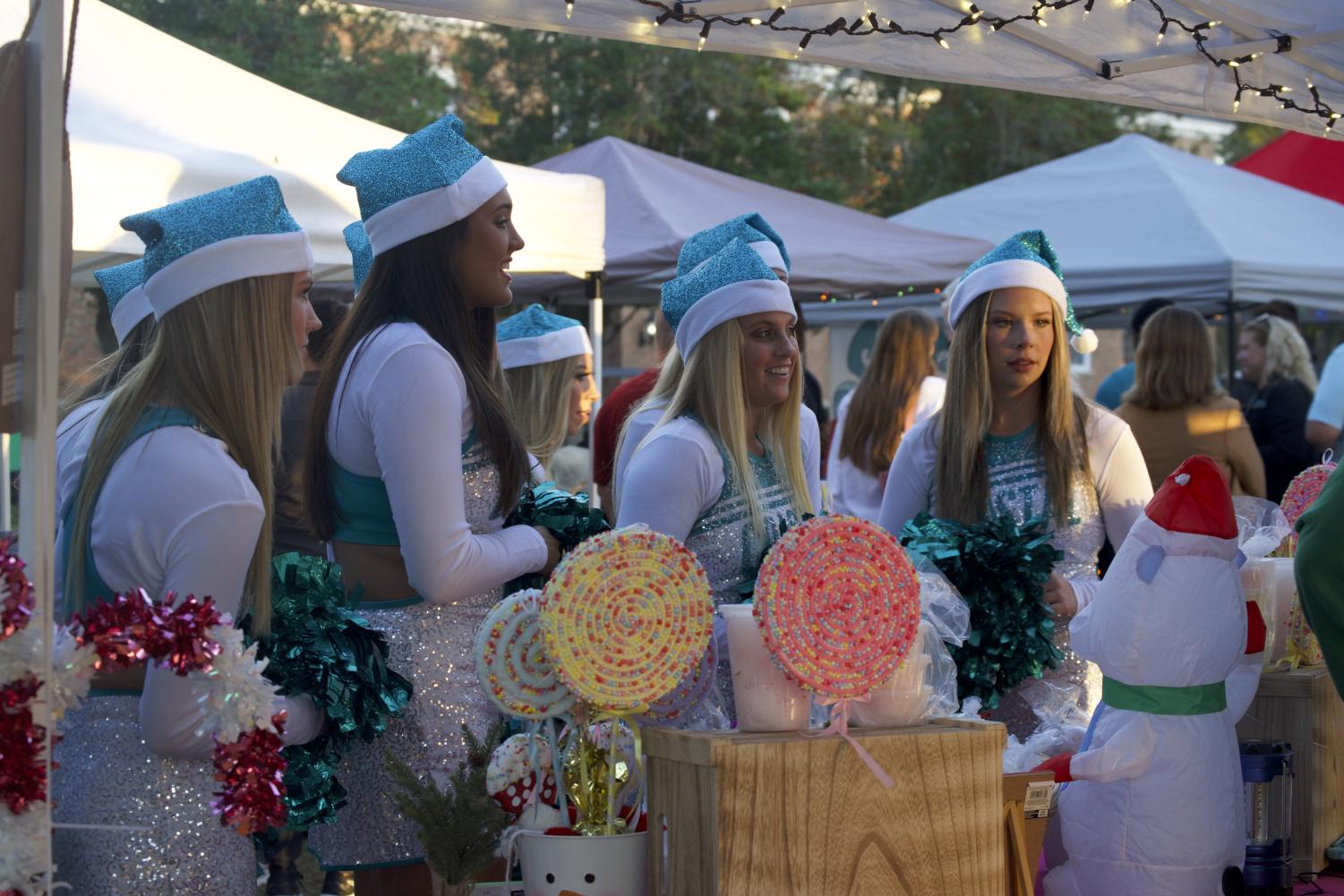 The CCU Dance Team talks with vendors and browses available items.