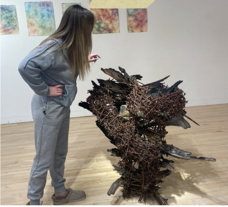 Jessica Conolly, Studio Art major and intern at the Rebecca Randall Bryan Art Gallery,
describes the elements of one of Marcia Wolfson Ray’s pieces. 