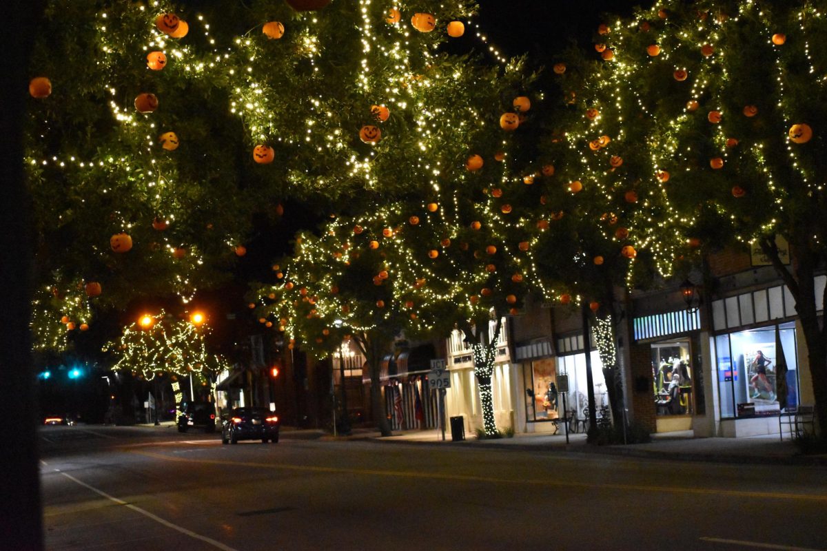 The streets of Halloween, South Carolina feature festive decorations including string lights and pumpkins.