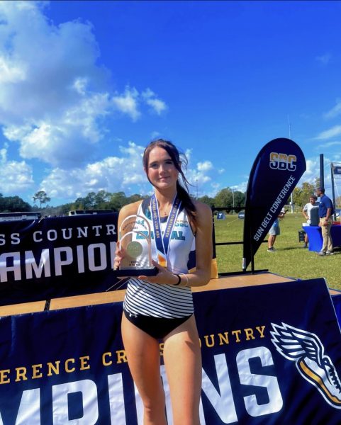 Senior intelligence and national security studies major Molly Jones celebrates her 2023 cross-country Sun Belt Conference Championship.