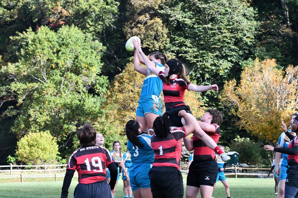 Sophomore Rory Markham and Senior Serafina Delgado participating in a line out against North Carolina State University.