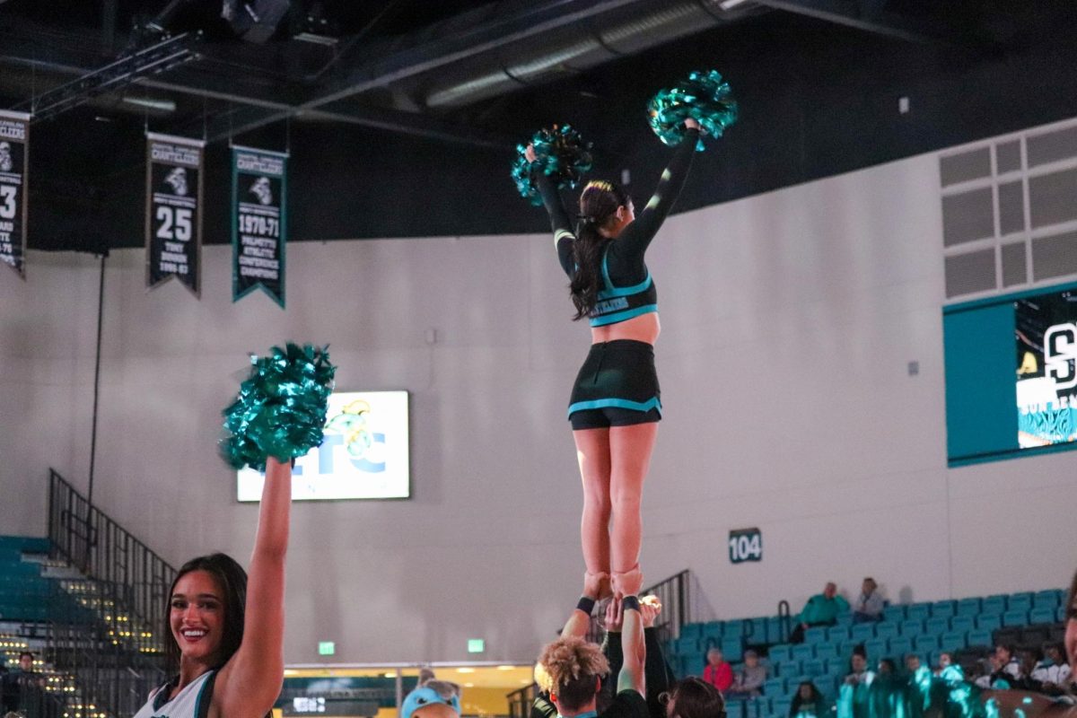Cheer+Team+Stunting+During+the+Womans+Basketball+Game