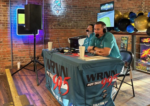 Head football coach Tim Beck (right) during his debut coaches' show at Chanti's Pizza in Conway on Aug. 27.