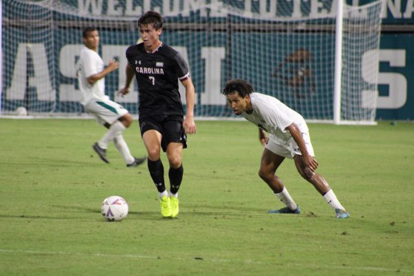 Gamecock Bryce Griffith maintains ball control from CCU midfielder Leon Olacio.