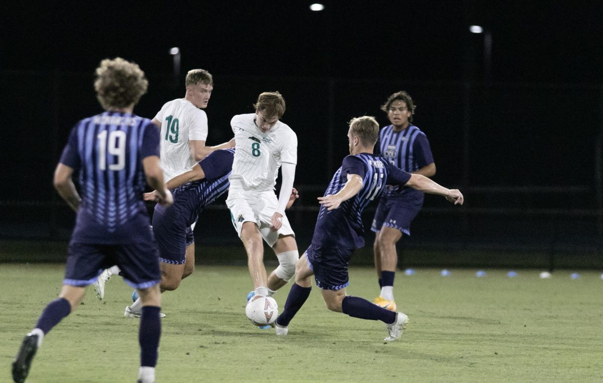 Loed Klaasen, midfielder, battles to maintain possession.