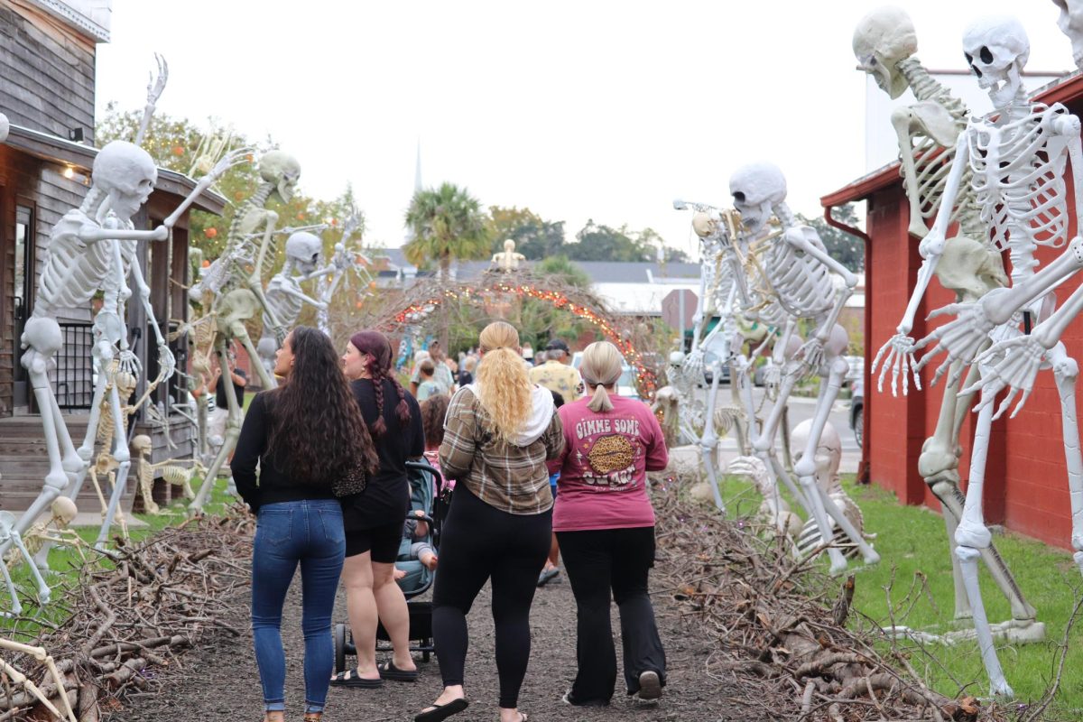 Members of the community enjoy the festive "Tunnel of Bones" attraction in downtown Conway Oct. 9.