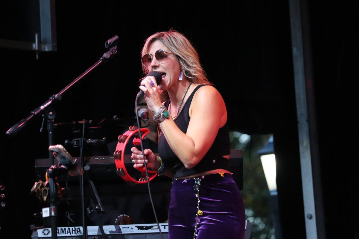 Elise Testone singing and playing tambourine during Music
on the Lawn on Oct. 18.