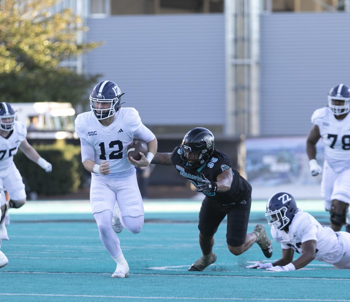 Barry Brown, linebacker, leaps for a tackle missing contact with the Georgia Southern ball carrier.