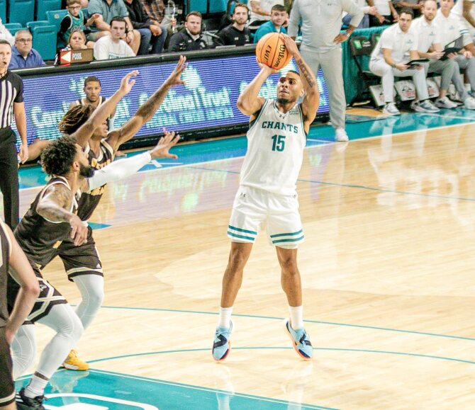 Jordan Battle, guard, makes a shot under heavy pressure. 