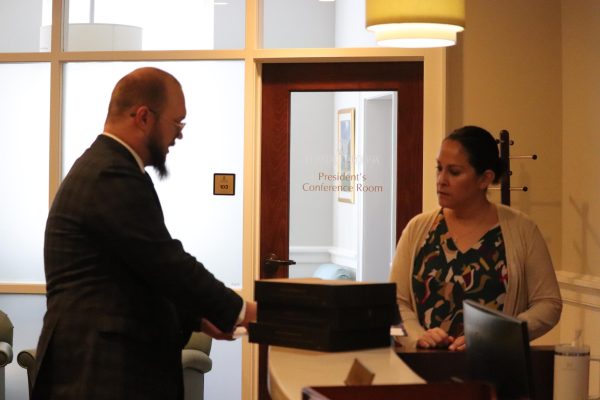 Senior Michael Wingo, representative of Chants for Liberty, speaking with Amanda Foss, executive assistant to the president.