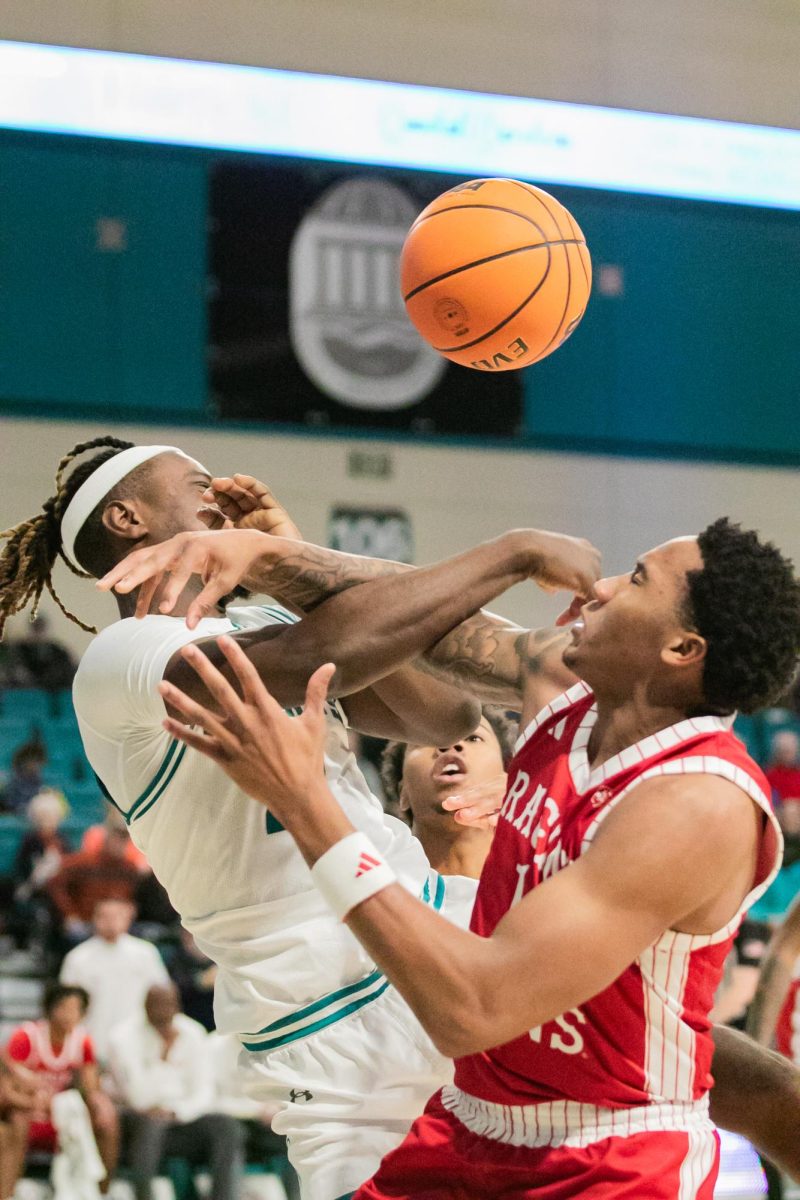 CCU's Rasheed Jones, guard, collides with Ragin' Cajuns player, Brandon Hardy.