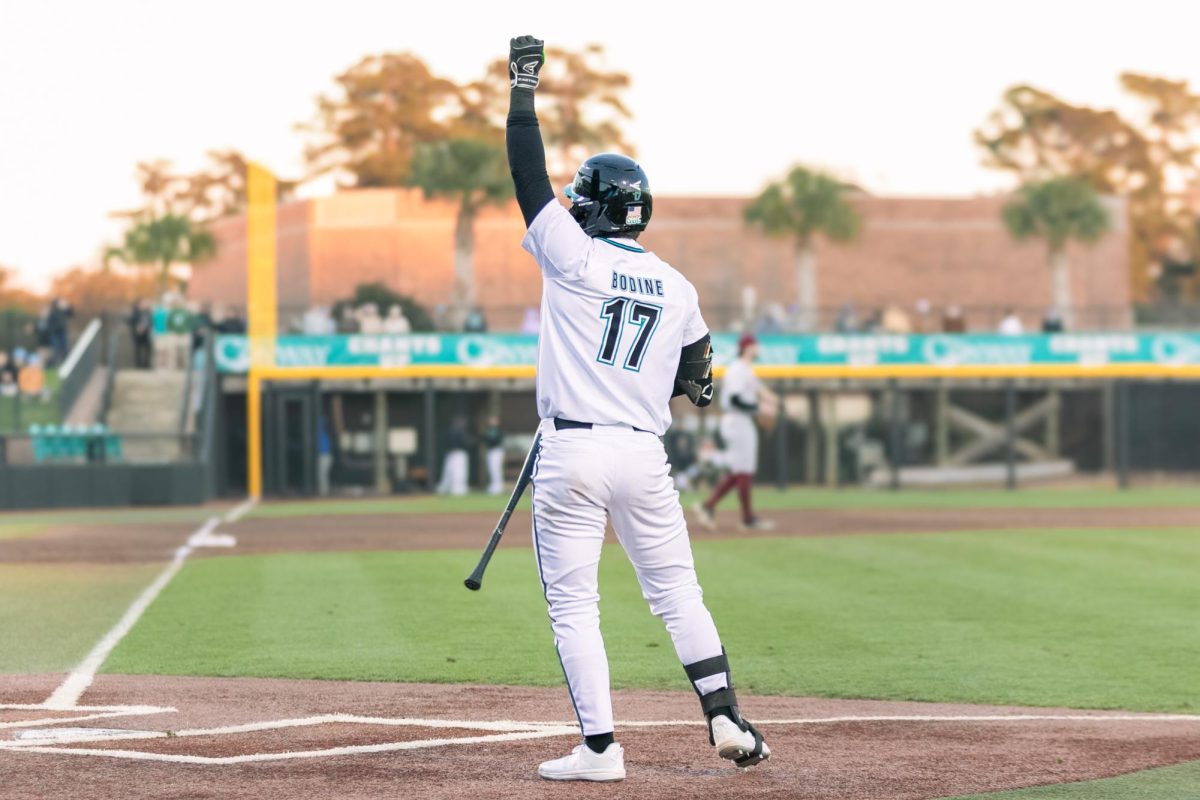 Caden Bodine celebrates a win over Kansas State University Feb. 15 during the "Baseball at the Beach" tournament.