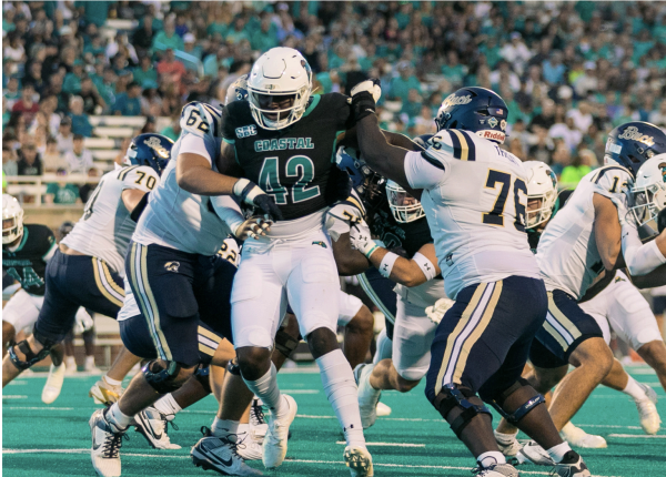 Defensive end Noah Arinze tries to break through Charleston Southern's offensive line 

 