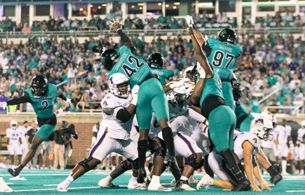 The Coastal defense attempts to block a field goal attempt by ECU. 