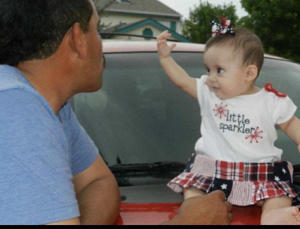 Photo provided by interviewee: "Papa" celebrates his granddaughter's first Independence Day. 