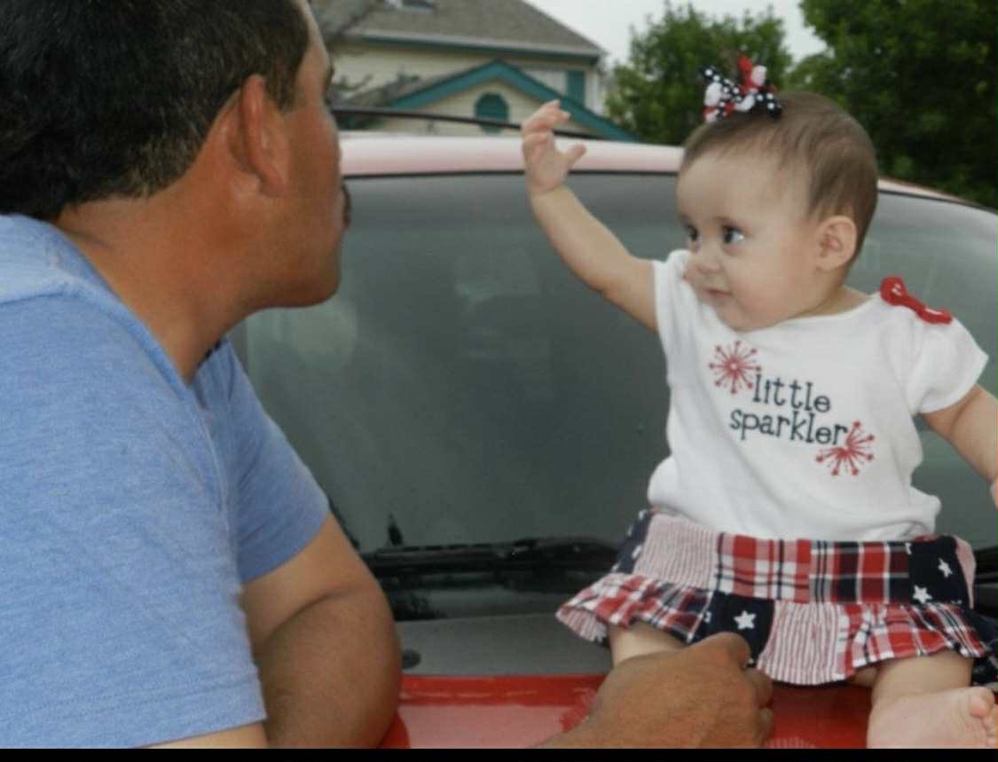 Photo provided by interviewee: "Papa" celebrates his granddaughter's first Independence Day. 