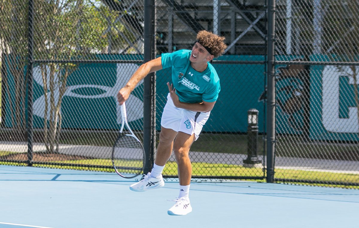 Iannis Fernandes serves the ball to Campbell University players 