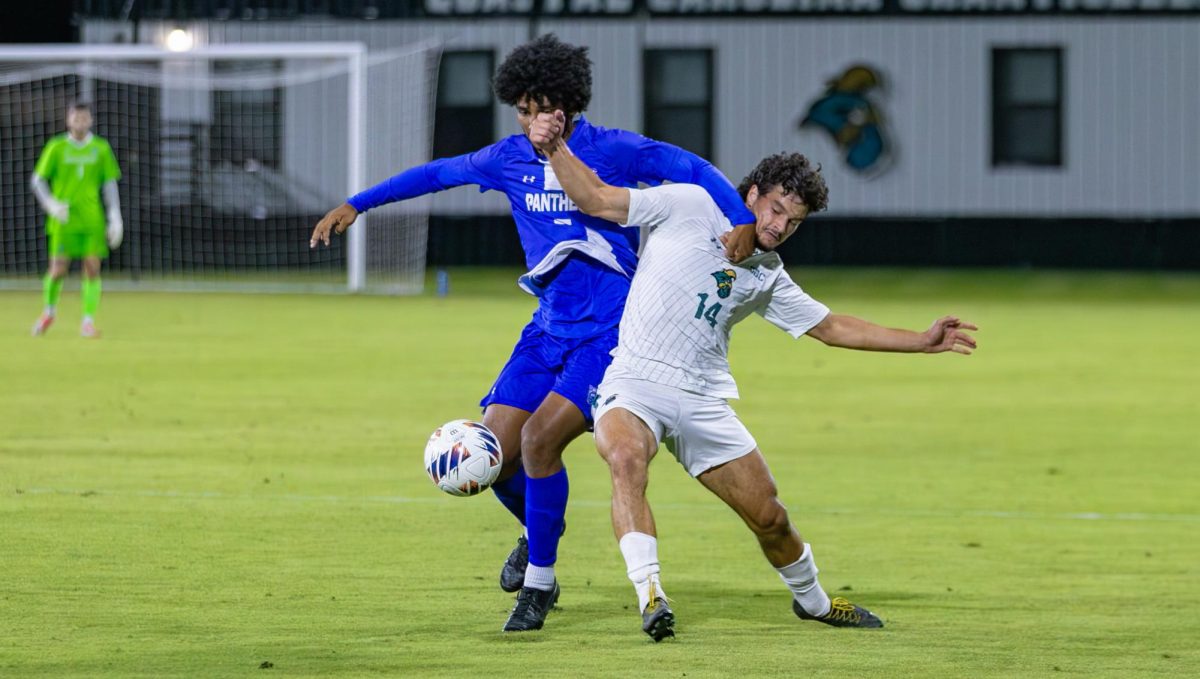 CCU forward Dominic Cintra battles for ball possession