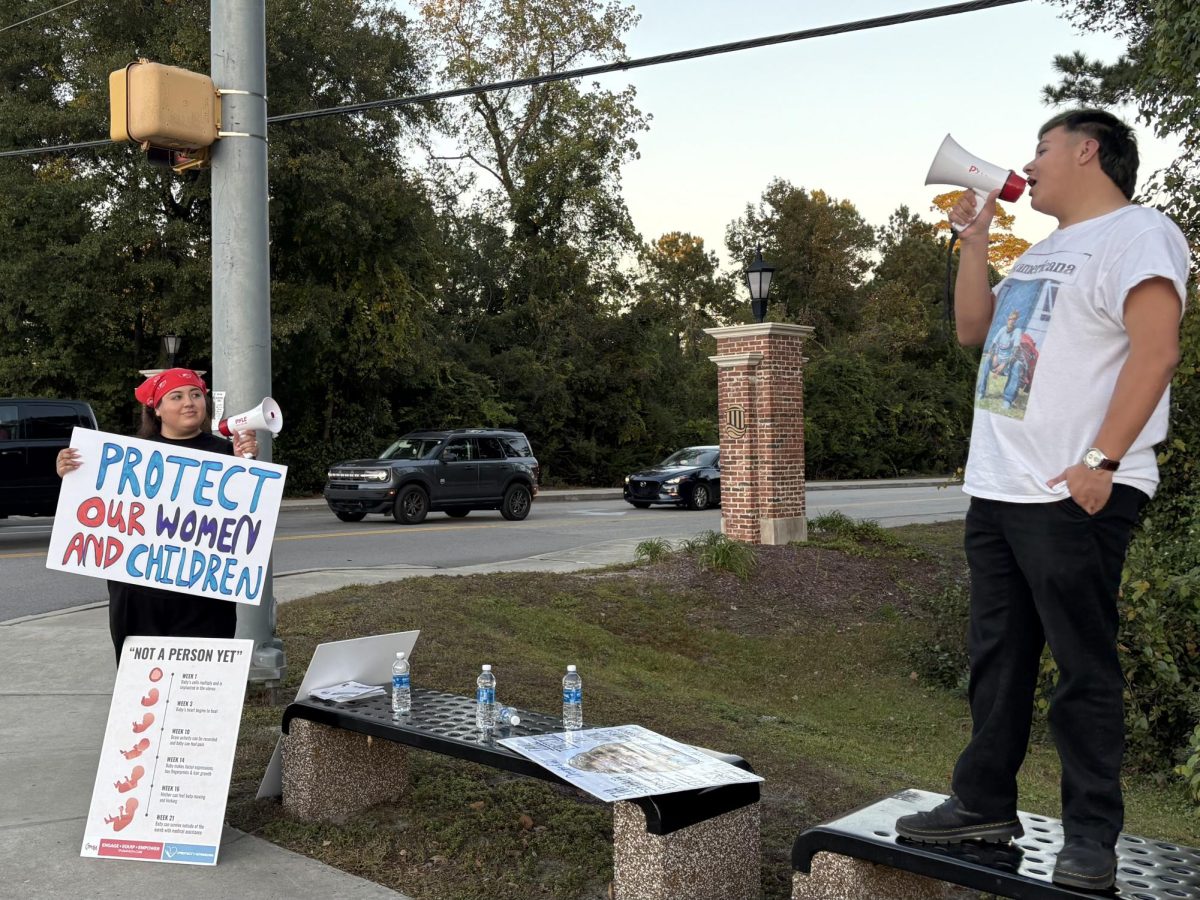 Activist protests across from Crooked
Floor Tavern, advocating for safer
alternatives to avoid potential
abortion-pill-induced risks.