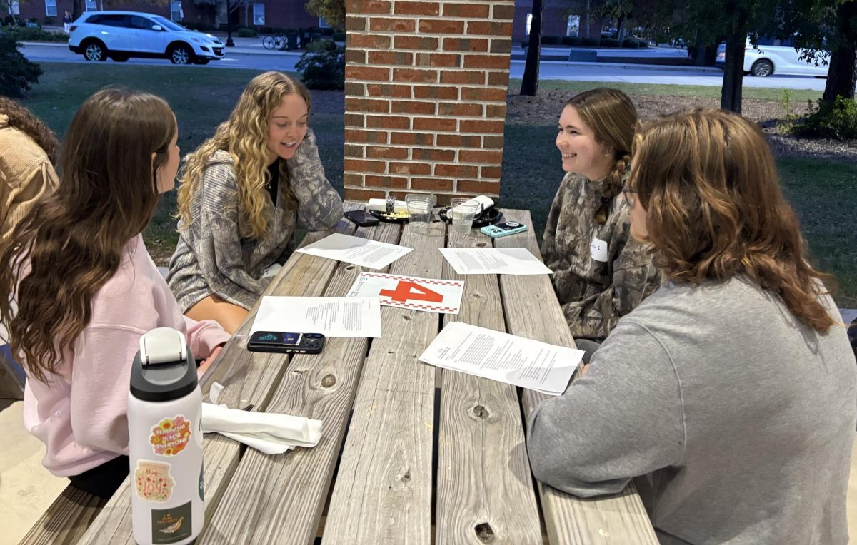 A group of students find commonalities while responding to controversial conversation prompts at the Civic Cookout.