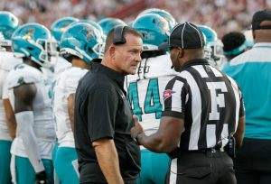 Coastal Carolina football Head Coach Tim Beck discusses a penalty call with the referee.