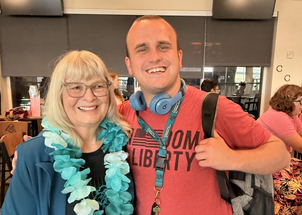 Previous CoastalLIFE Director Cheryl Morgan stands with sophomore Lawson Canon at her retirement party. Photo provided by Cheryl Morgan