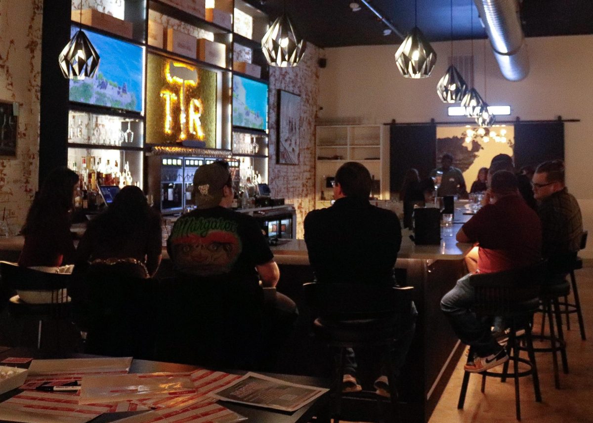 Guests take a moment to enjoy drinks and conversation at the local singles gathering.