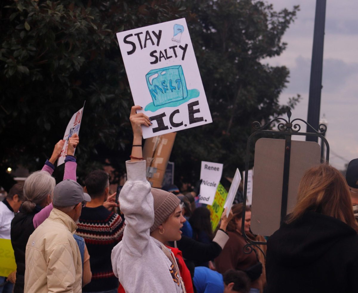 A student holds a sign reading “STAY SALTY I.C.E.” with a melting ice cube in a crowd of protesters during a nationwide nonviolent demonstration on Jan. 23.