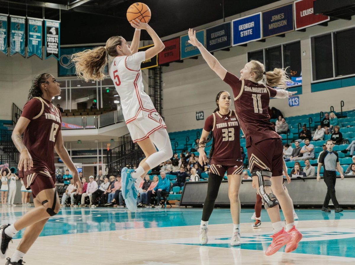 Coastal Carolina University guard Kristin Williams jumps for a shot against Texas State University. 