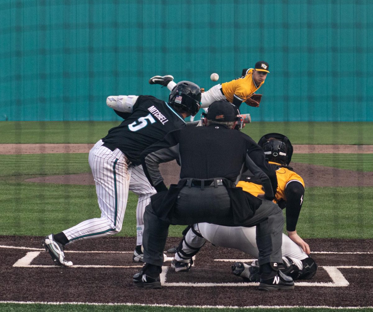 Infielder Walker Mitchell attempts to bunt a pitch from VCU.