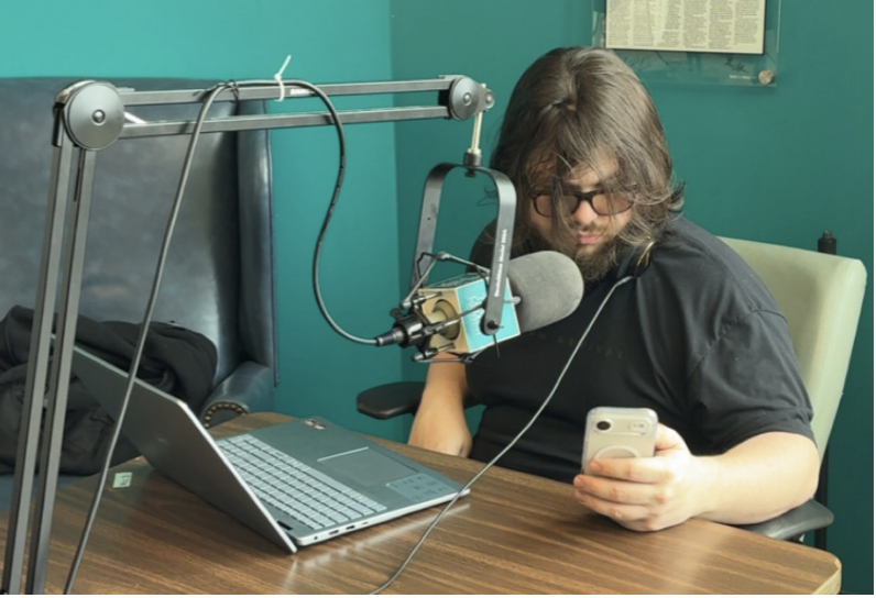 Logan Burrell records an episode of "Built Different" in the WCCU Radio station on campus. Photo provided by Phillip Burrell..